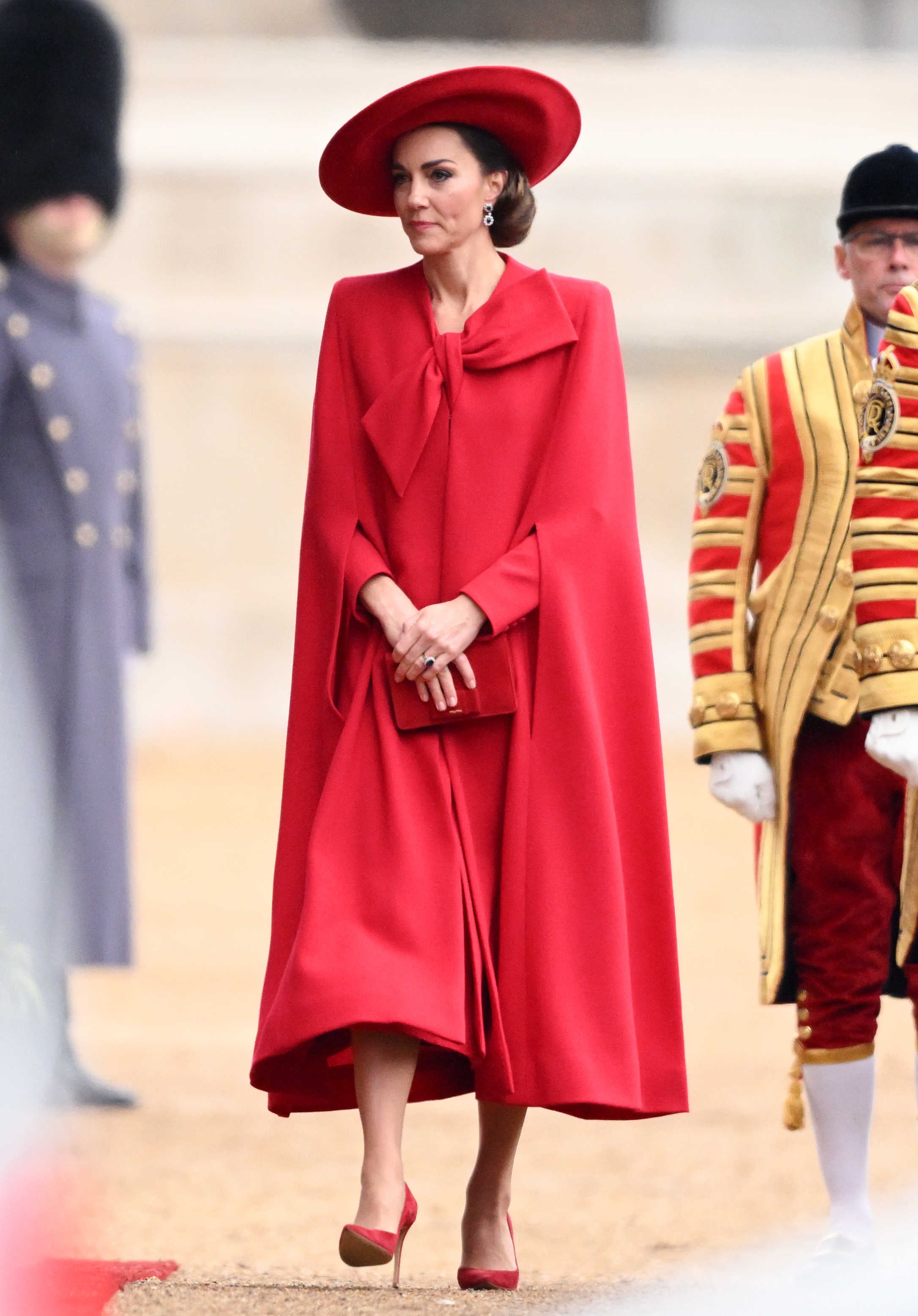 Kate Middleton Is a Standout in New Red Cape and Hat While Hosting